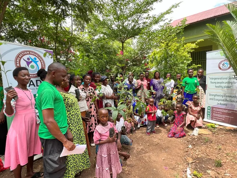 A large crowd of children and adults gathers outside for a resilience project event