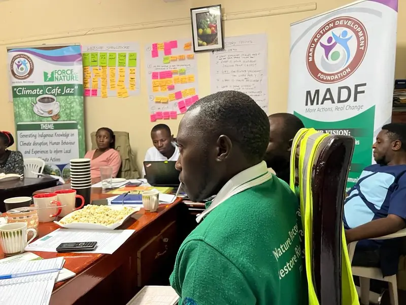 Participants work at a table during a Climate Café session in the office