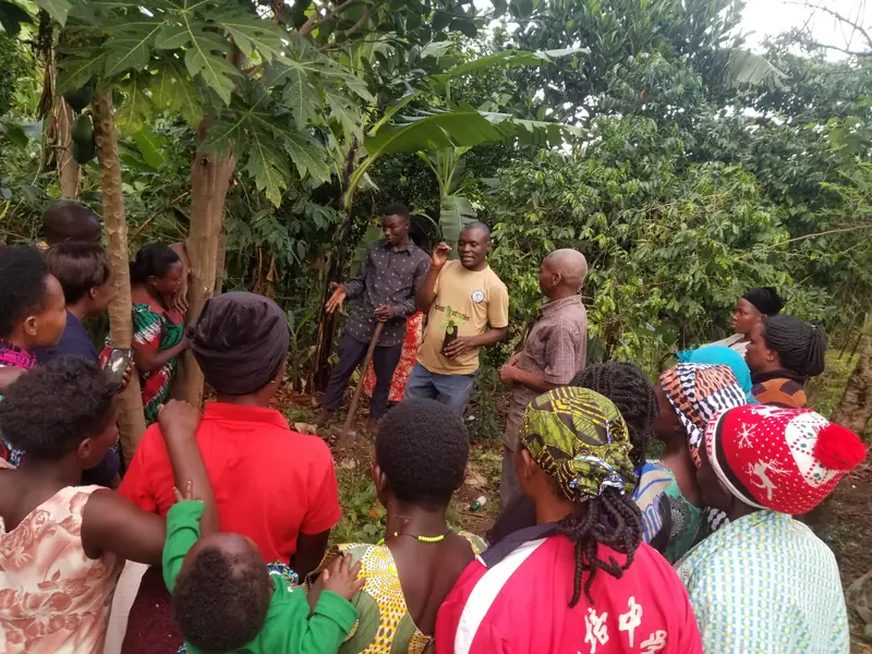 Community members listen during an outdoor Compassion in Action meeting