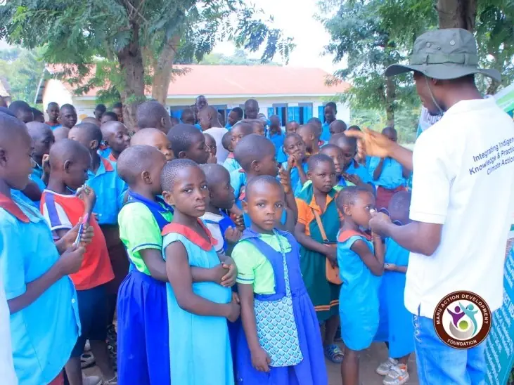 Pupils line up in a schoolyard during a community outreach visit