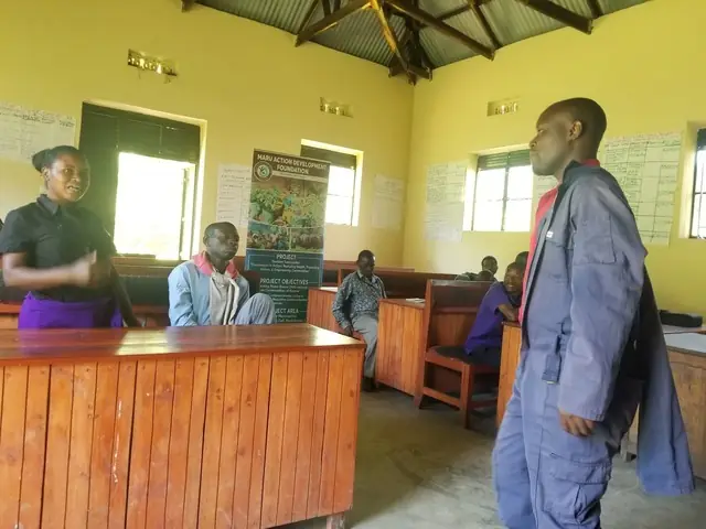 A facilitator speaks to participants in a school classroom