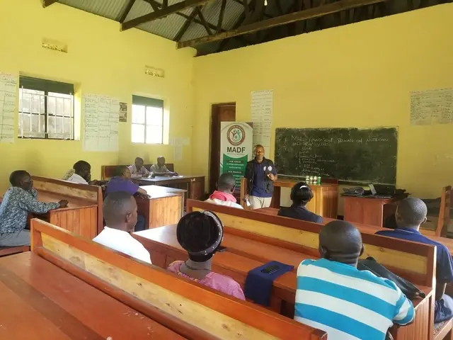 Participants listen during a climate session in a school classroom