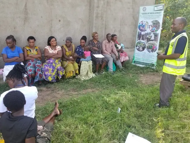 Women sit along a wall during a Seeds of Resilience training session